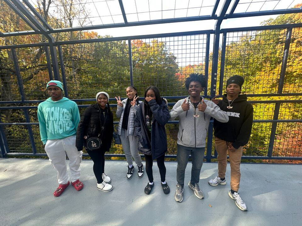 Charter school students posing for a photo on the blue bridge in Allendale